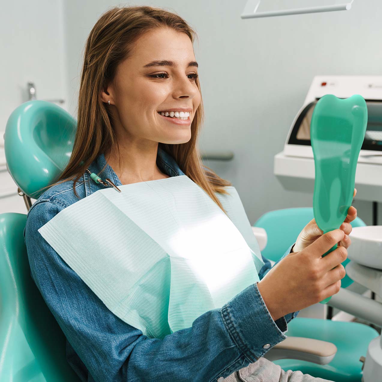 Young adult examining her teeth